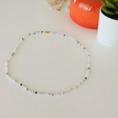 Australian opal bead necklace on a stand showing deep blue and fiery red opal