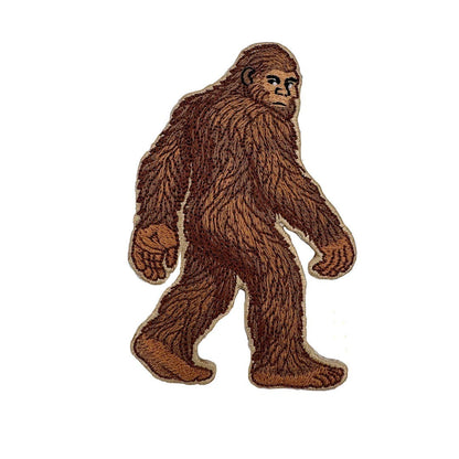 Embroidered patch of a brown Bigfoot figure on a white background