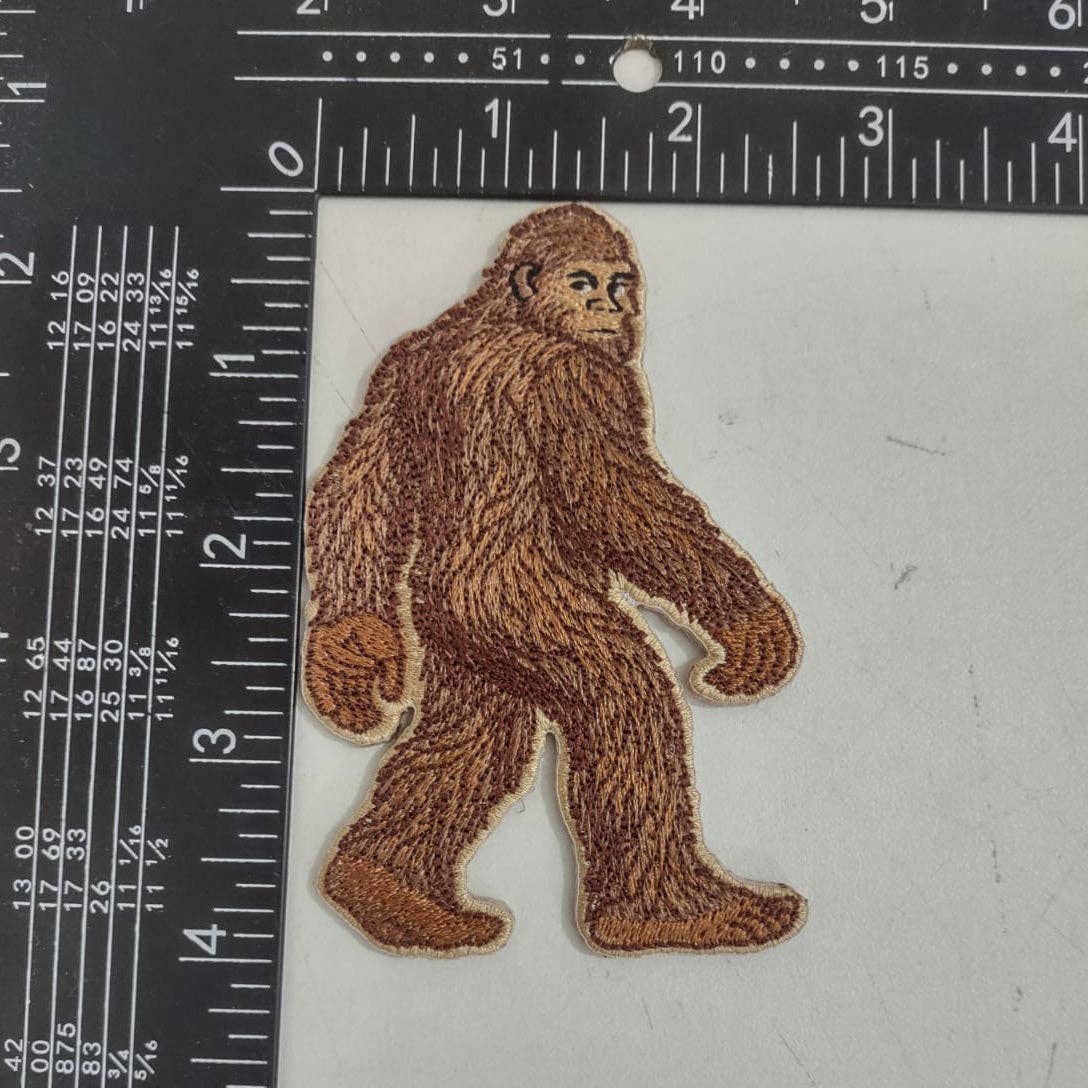Sasquatch patch next to a ruler on a white background