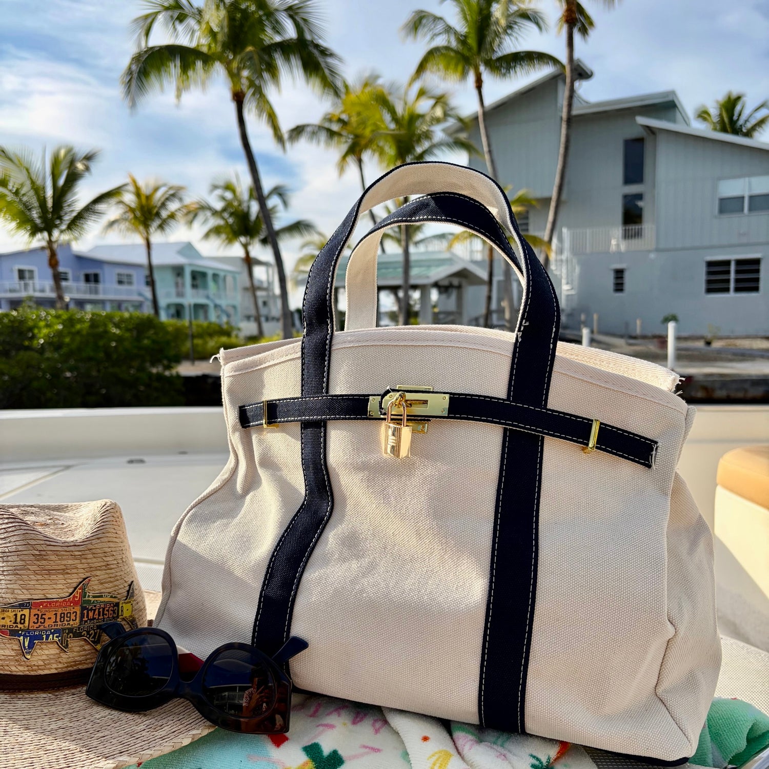 Boatkin bag on a boat deck with palm trees and waterfront homes