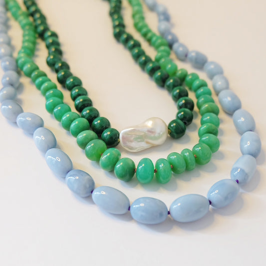 Blue opal beaded candy necklace layered with other beaded necklaces
