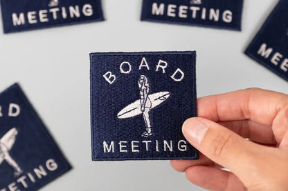 Board Meeting embroidered iron-on patch with a line drawing of a surfer