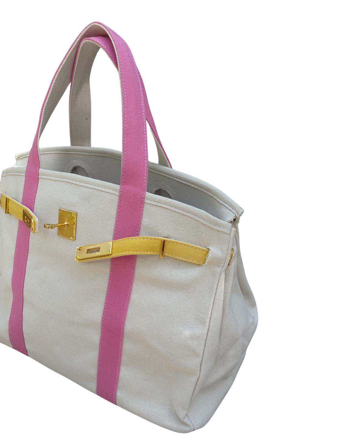 Pink and yellow Boatkin bag side view on a white bakcground.