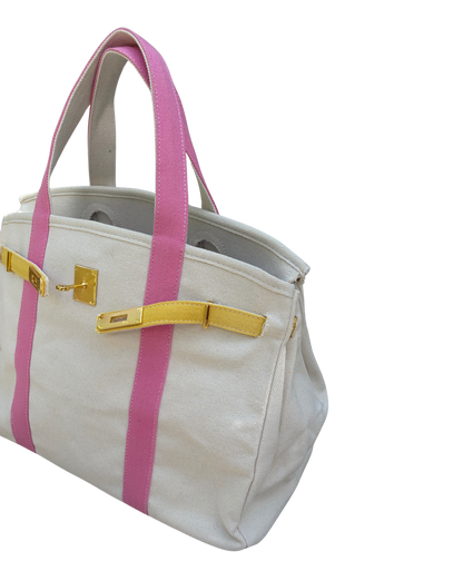 Pink and yellow Boatkin bag side view on a white bakcground.