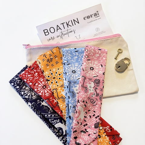 Boatkin bag free styling kit featuring patterned twilly scarves, a lock accessory, and care instructions card.
