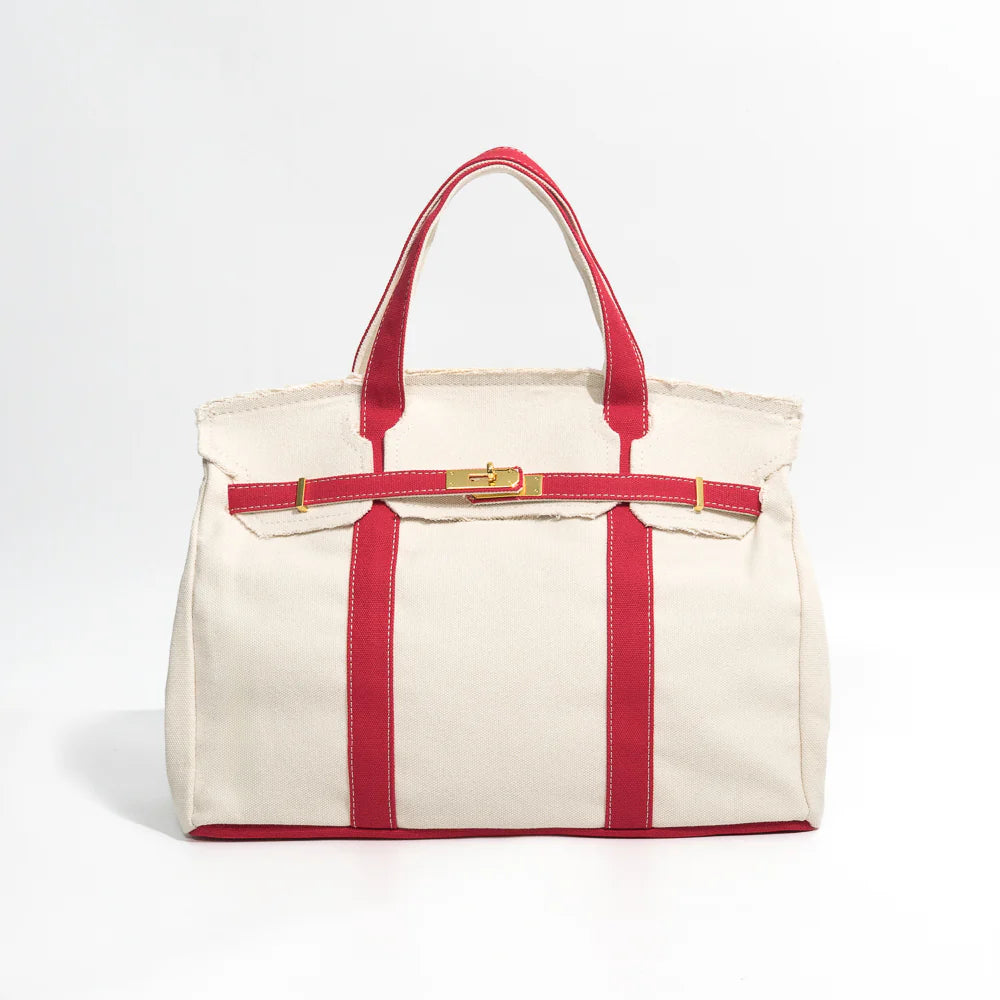 Boatkin canvas tote bag with red straps on a light gray background
