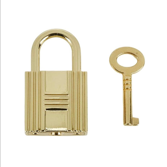 Boatkin gold lock with a matching key on a white background