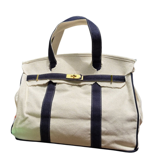 Front view of the cream canvas Boatkin boat tote bag featuring navy blue straps and a matching navy horizontal strap.