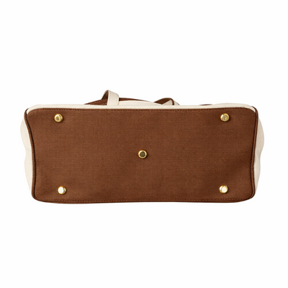 Brown Boatkin bag bottom showing gold protective feet on white background