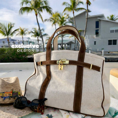 Brown Boatkin bag on a boat deck with palm trees and waterfront homes