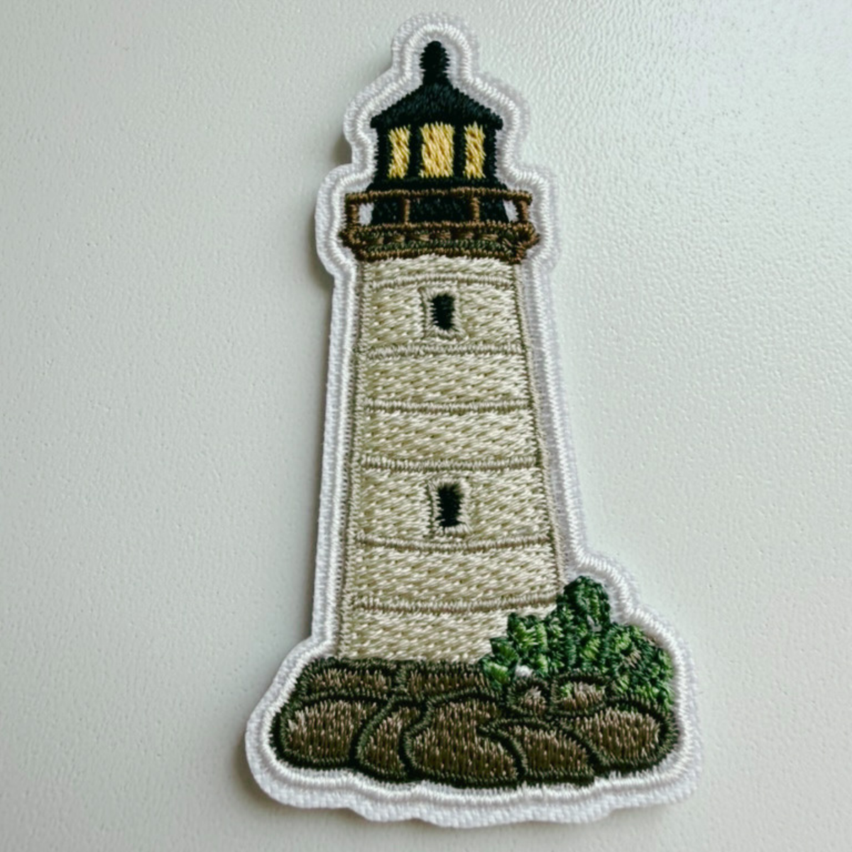 Coastal lighthouse embroidered iron-on patch close-up