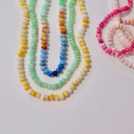 Colorful beaded candy necklaces and bracelets on a light background