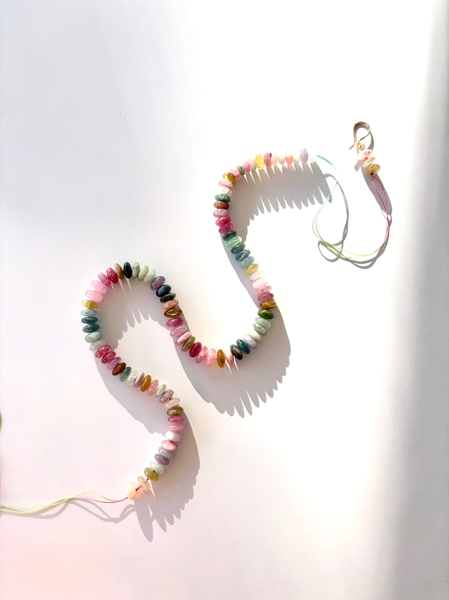 Colorful watermelon tourmaline beaded necklace on a white background
