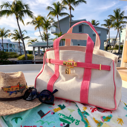 Coral Boatkin bag on a boat with palm trees in the background