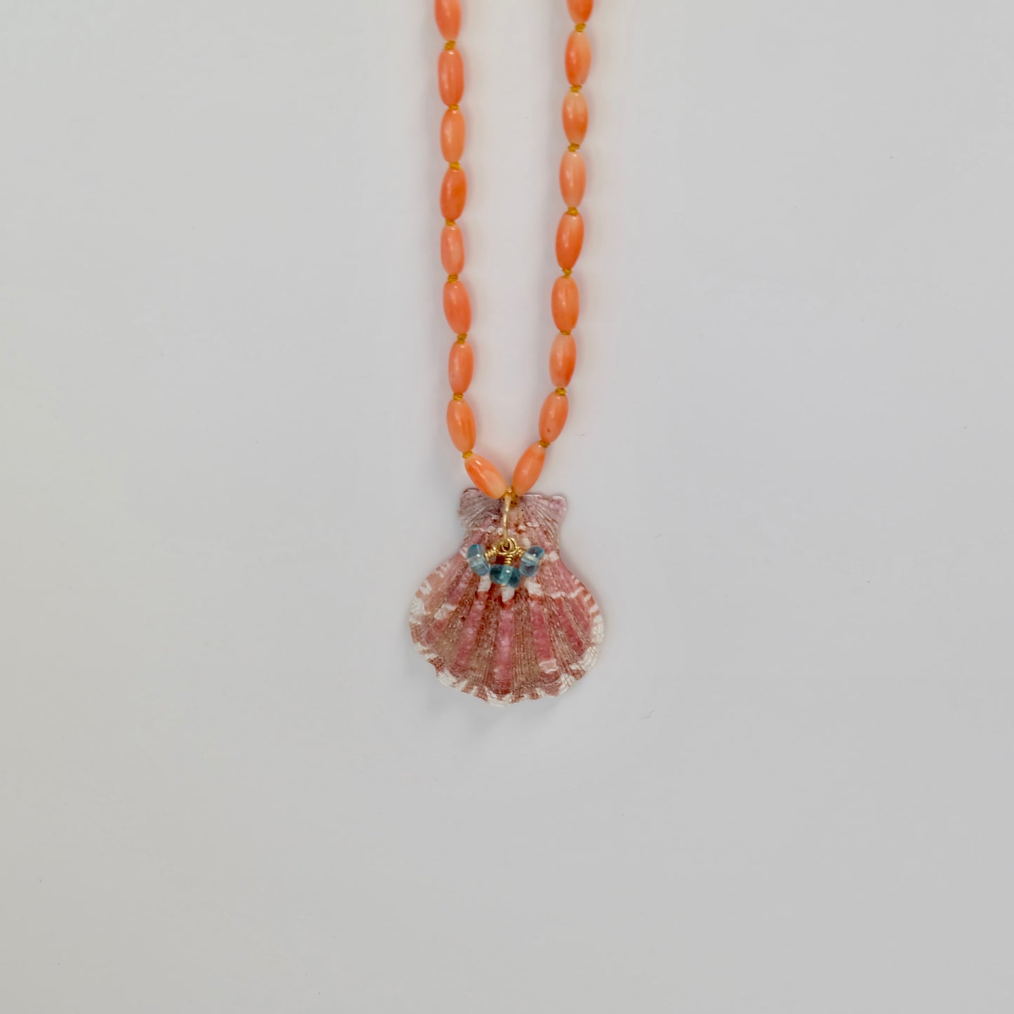 Detail of 14K gold-filled lobster clasp on the Coral Necklace with shell and neon apatite charms