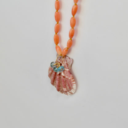 Coral Necklace layered with gold chains, highlighting its 19-inch length and vibrant ocean-inspired hues.