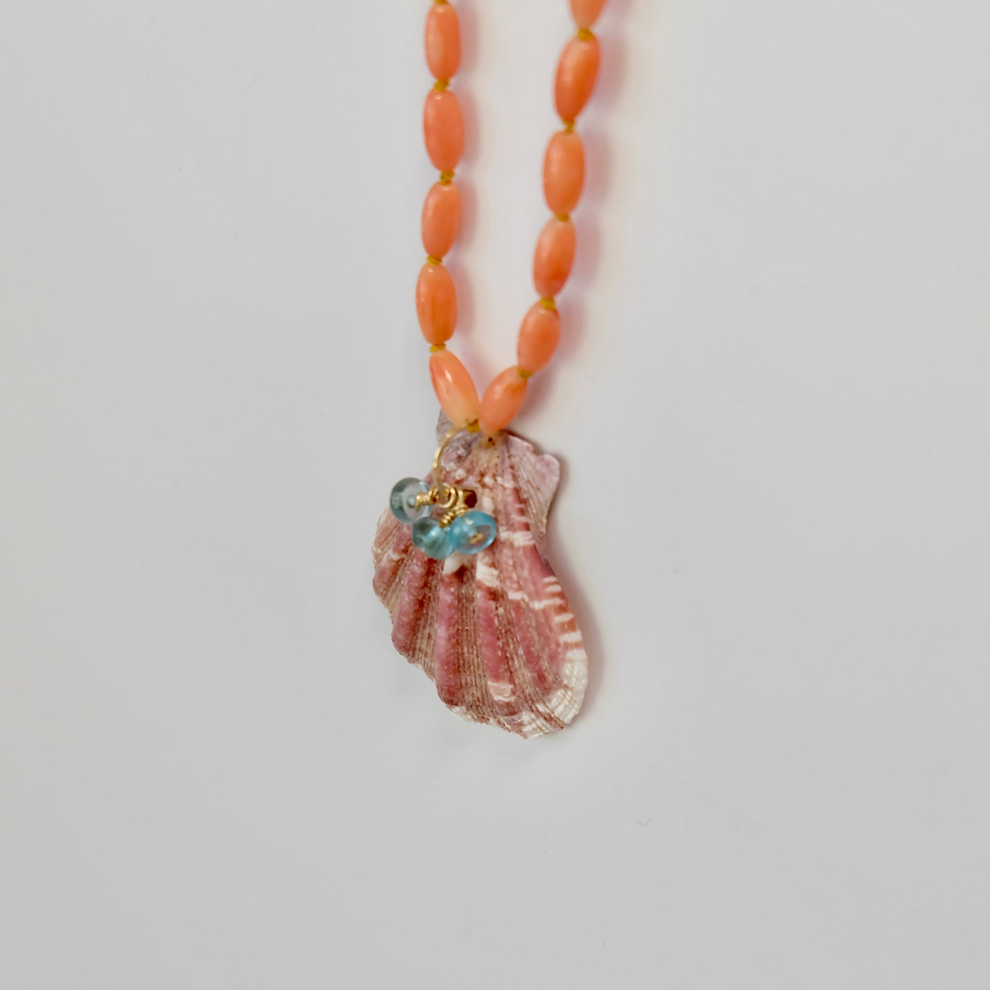Side view of Coral Necklace with shell and apatite charms