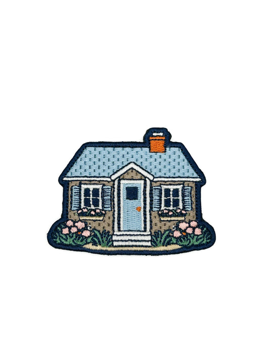 Cottage house embroidered iron on patch with blue door and florals, 2x2.75 inches