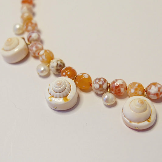 Pair of handmade cowrie shell and pearl earrings in 14K gold-filled