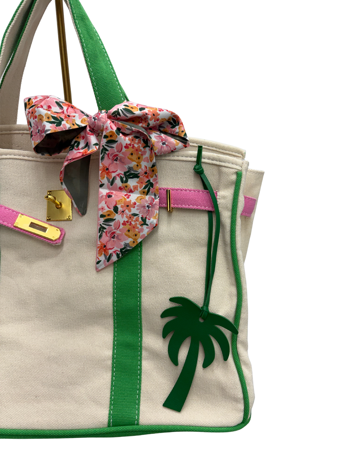 A close-up of a custom bag with pink and green trim and palm tree.