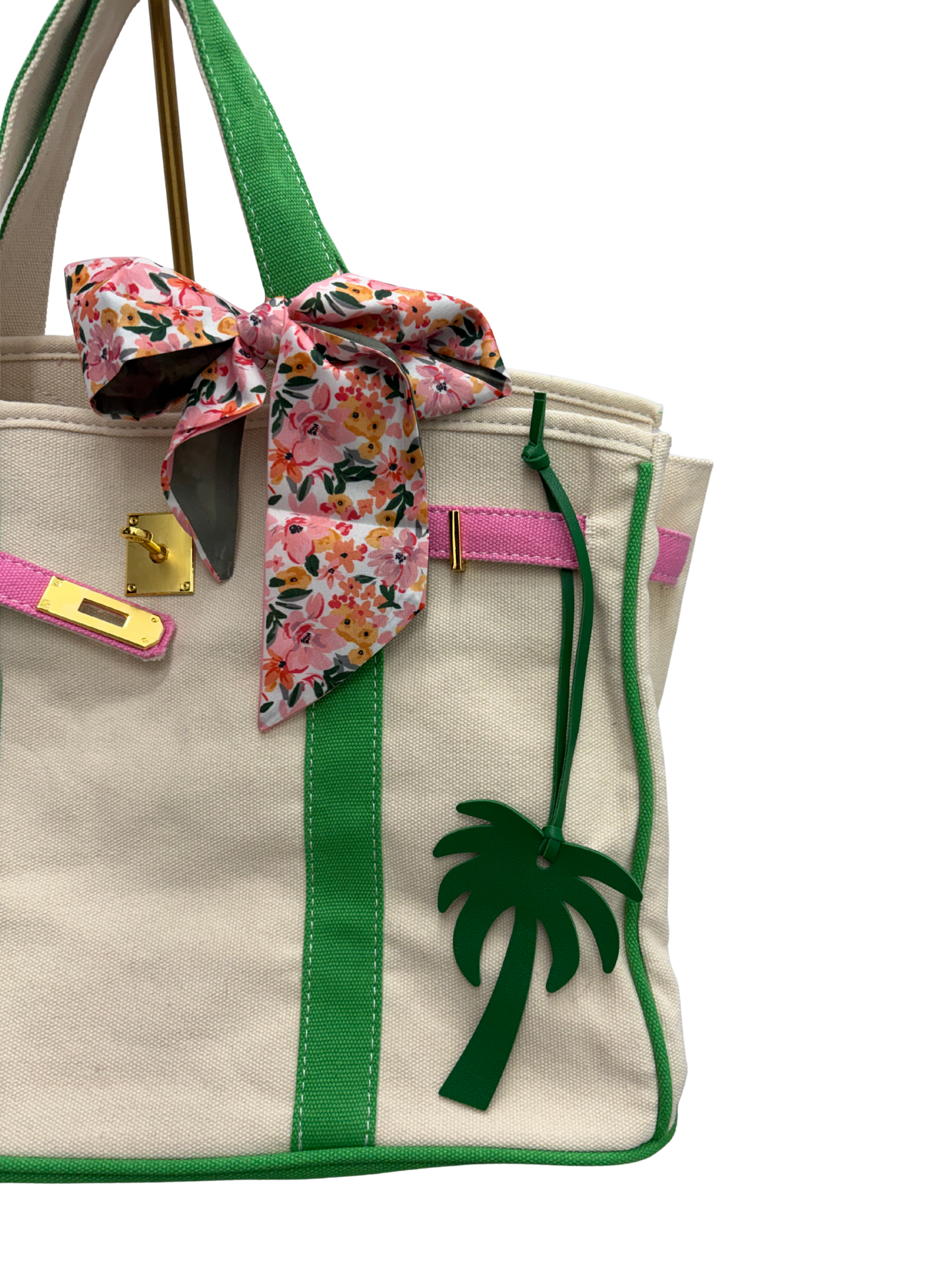 A close-up of a custom Boatkin bag with pink and green trim and palm tree.