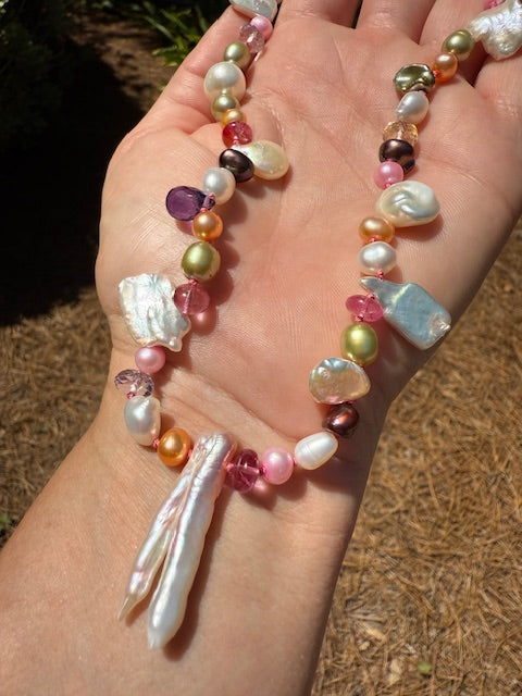 Detail of Biwa pearls and gemstones hand-knotted on fuchsia silk