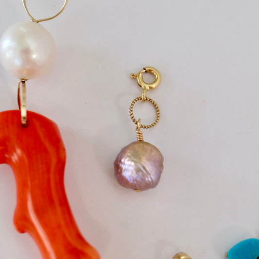 Freshwater pearl charm on 14k gold, handcrafted for elegance and luxury in any jewelry collection.