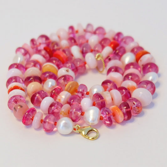 Display of Gemmy Gem Necklace with pink topaz, opal, pearls, and orange silk