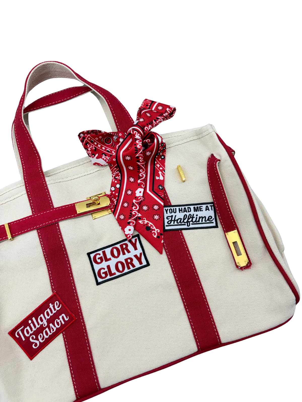 Close up view of Georgia Bulldogs college football tote bag in beige canvas with red structural trim, showing custom Glory Glory and You Had Me At Halftime patches alongside a red paisley twilly scarf.