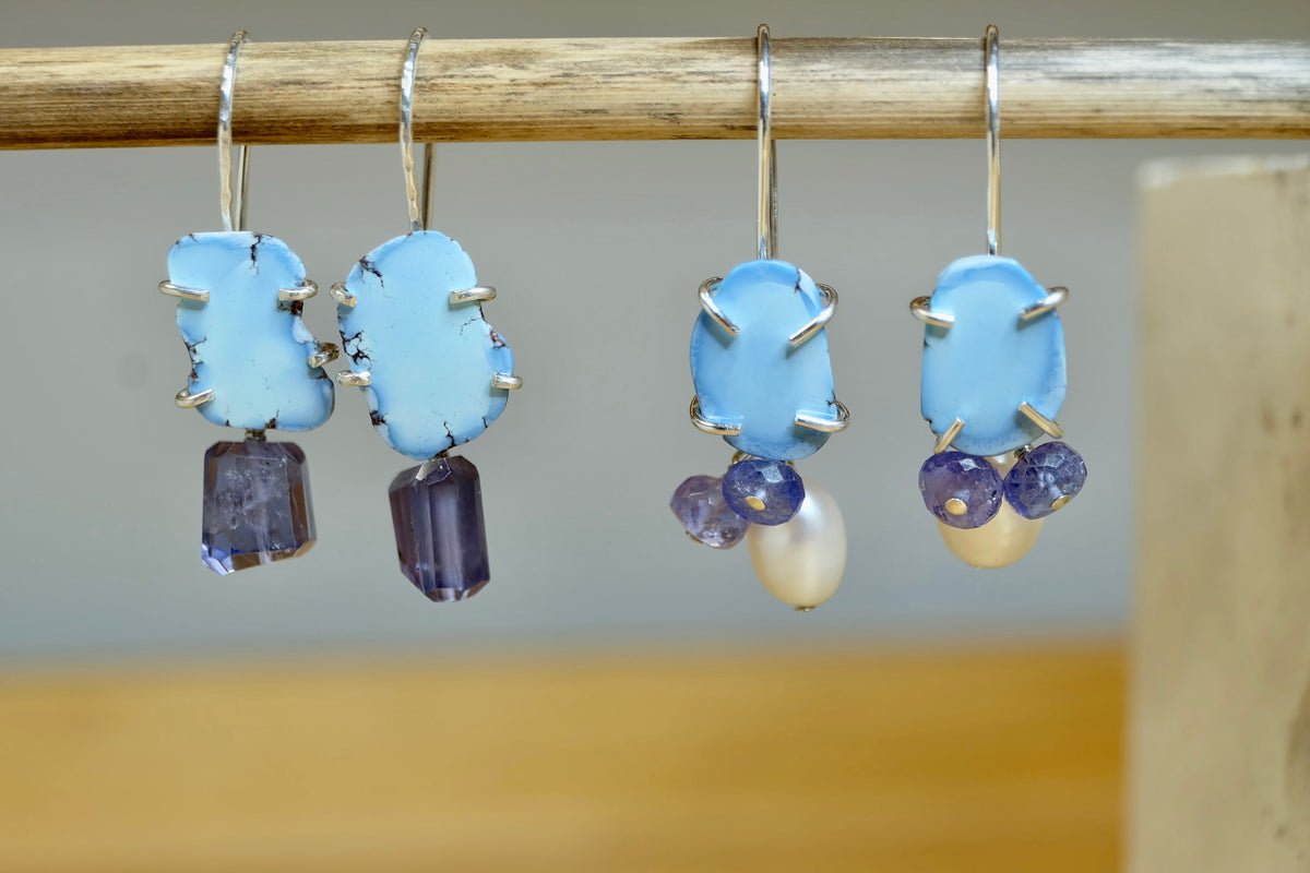 Front view of Golden Hills turquoise dangle earrings with lavender matrix and iolite