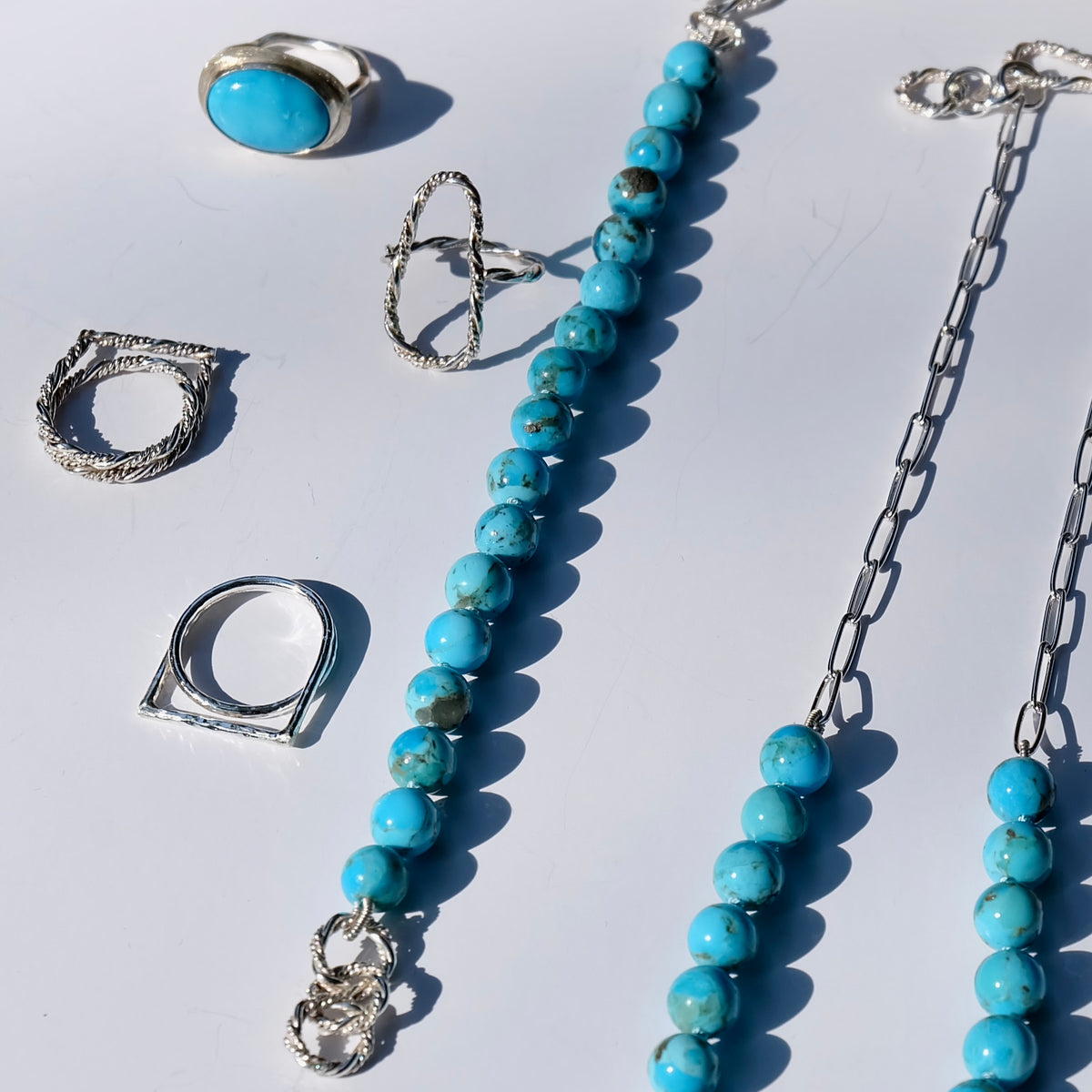 Kingman turquoise beaded bracelet styled with silver rings