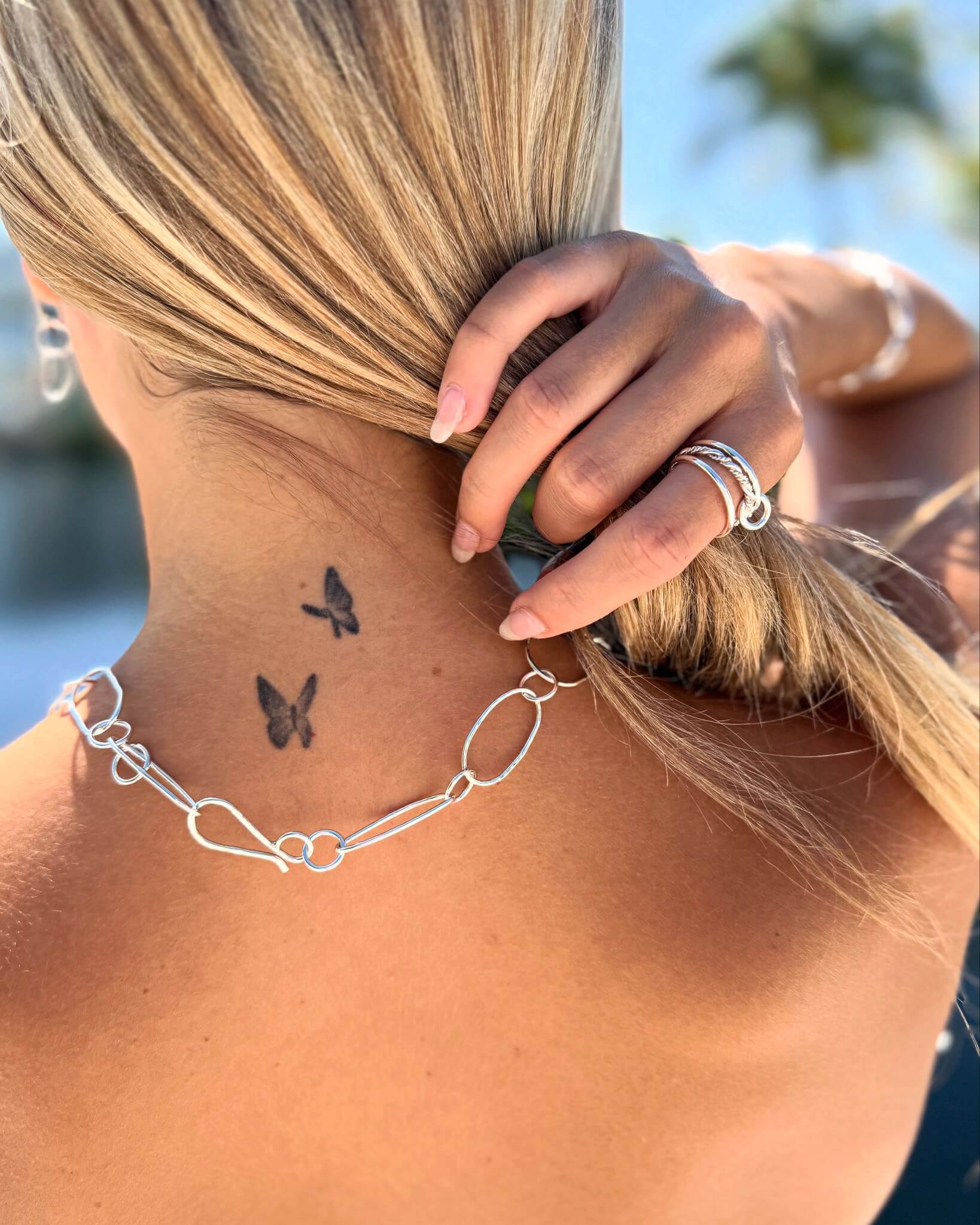 Handmade silver chain necklace worn by woman.