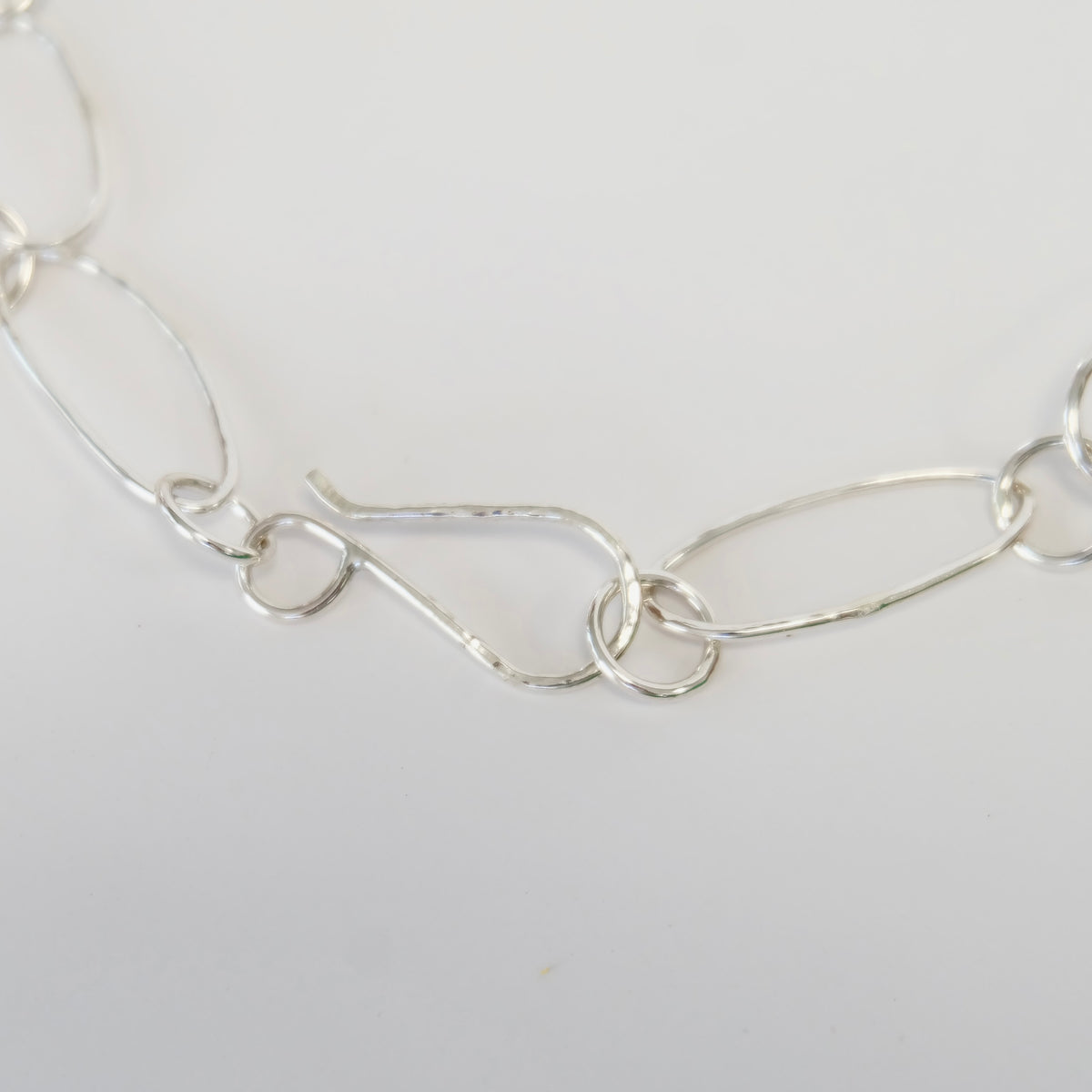 Oversized hand-forged sterling silver S-hook clasp on a paperclip link necklace
