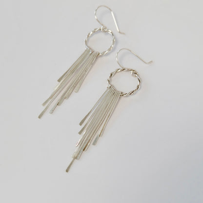 Handmade sterling silver tassel earrings laid flat