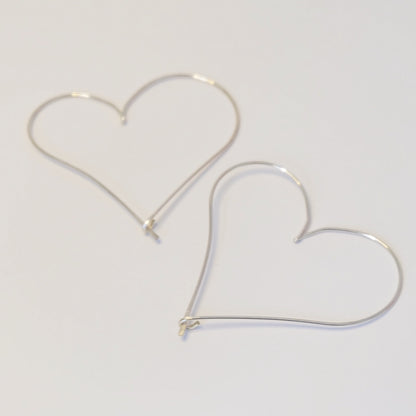 A pair of elegant heart-shaped hoop earrings, showcasing a stylish and romantic design perfect for any occasion.