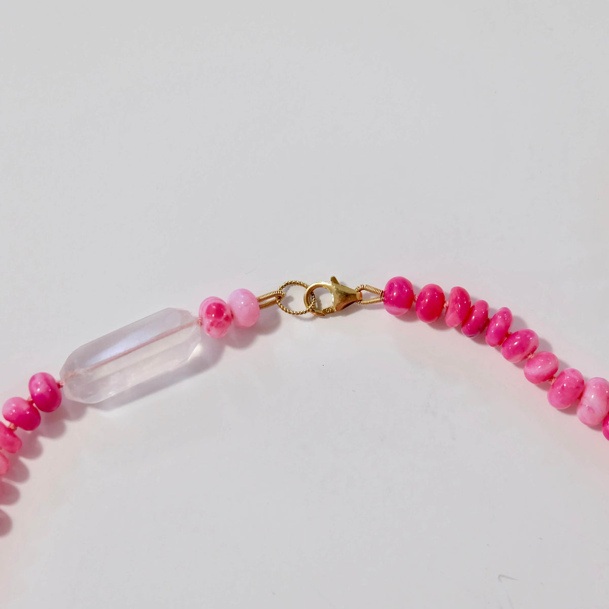 Close-up of the rose quartz center nugget on a hot pink opal candy necklace