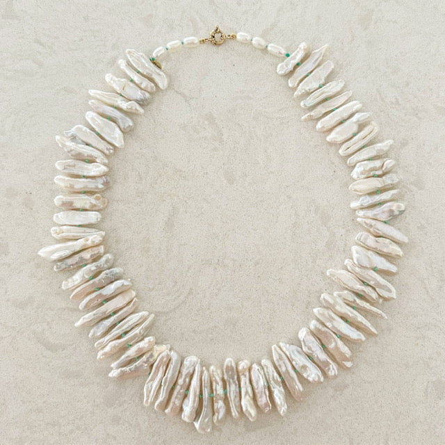 Elongated Japanese Biwa pearls with a 14K gold clasp