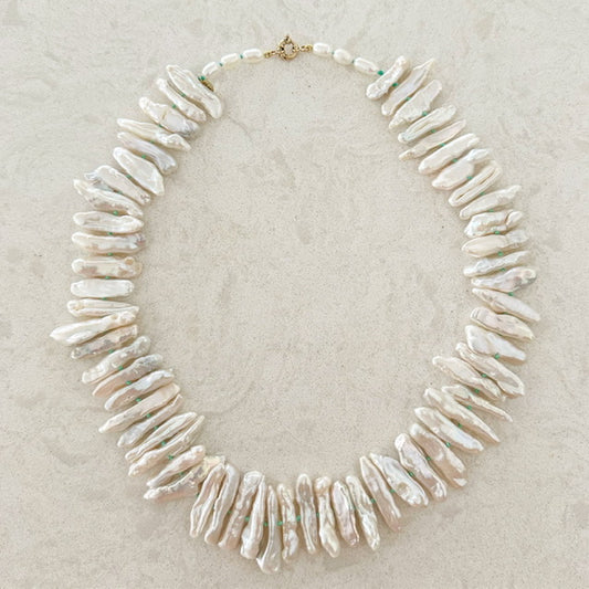 Elongated Japanese Biwa pearls with a 14K gold clasp