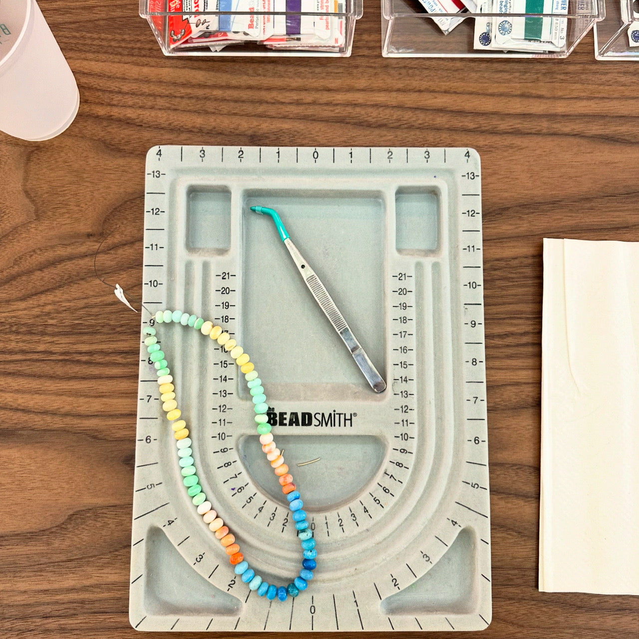A colorful gemstone candy necklace laid out on a design board during a Key West jewelry class.