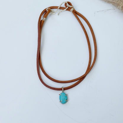 Kingman turquoise charm necklace on a brown suede cord