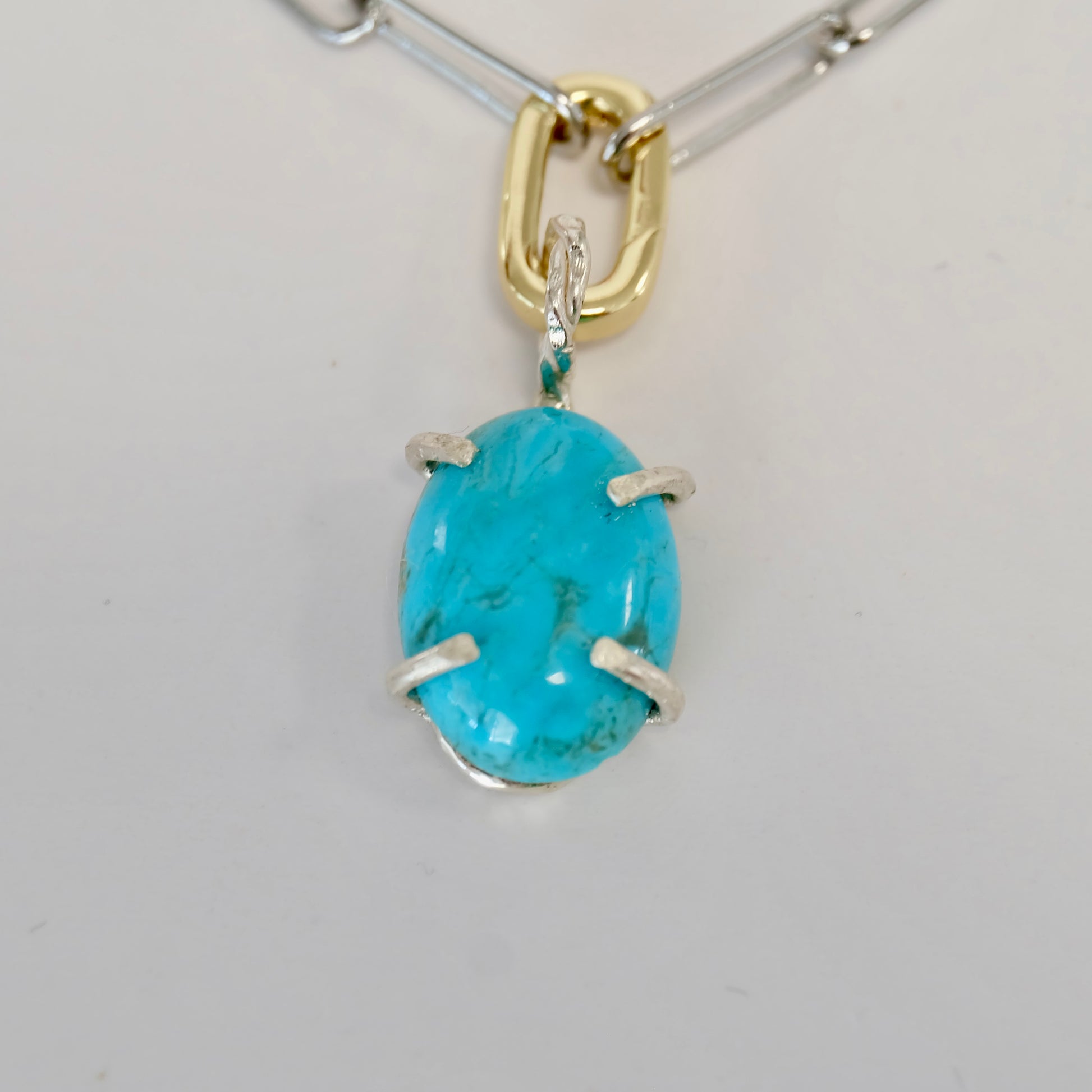 E Handcrafted turquoise charm made of sterling silver, showcasing vibrant Kingman turquoise, perfect for all occasions.