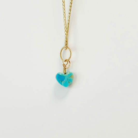 Blue Kingman turquoise heart charm with a gold spring clasp