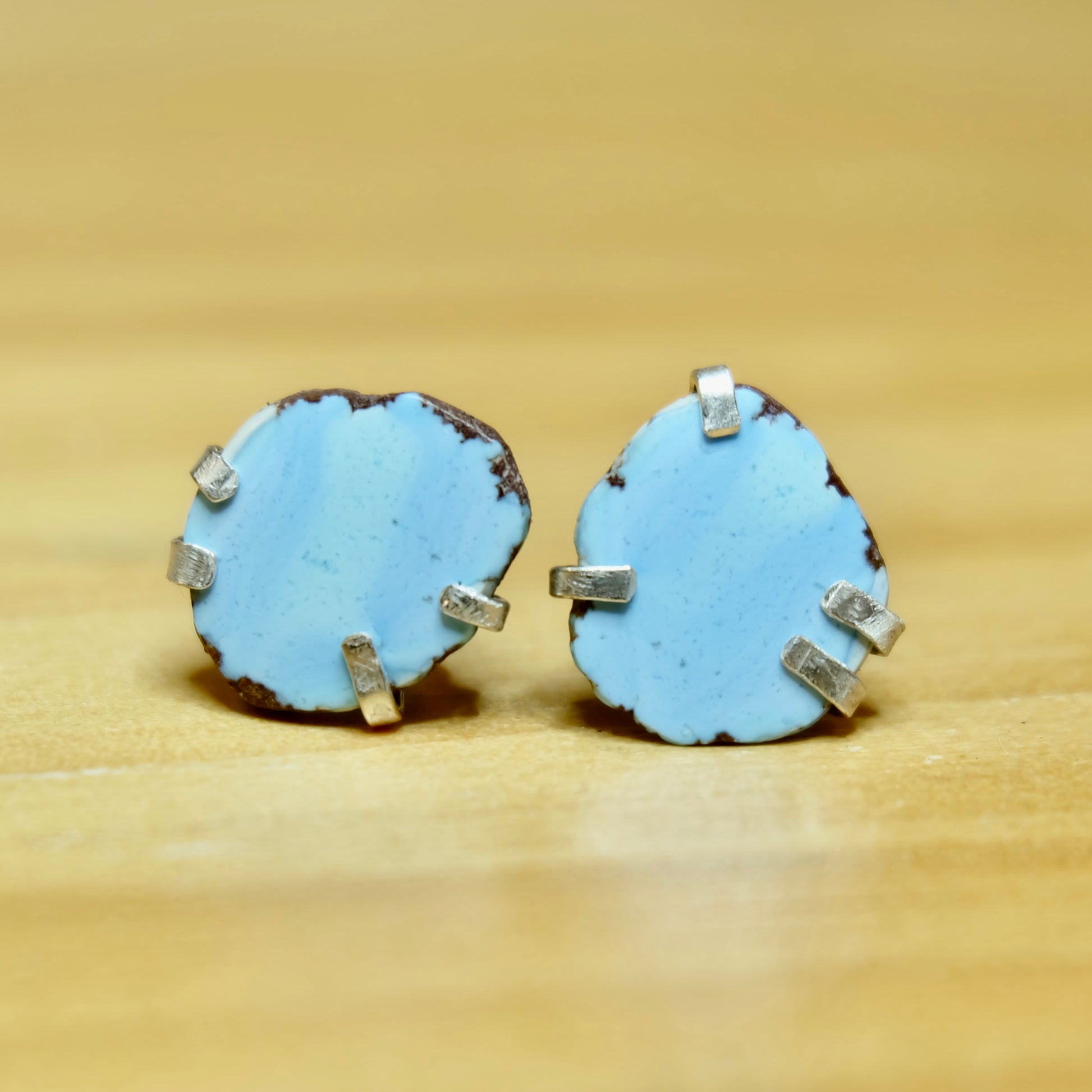 Display of Golden Hills Turquoise Stud Earrings in silver showing lavender hues 