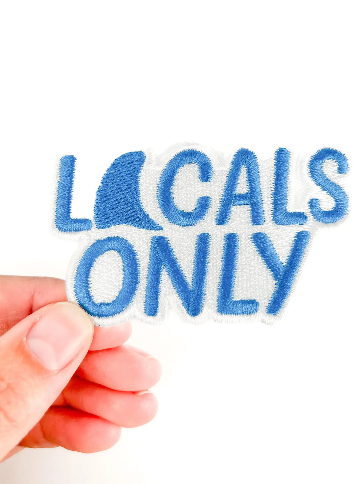 Locals Only embroidered iron-on patch with shark fins in sky blue thread