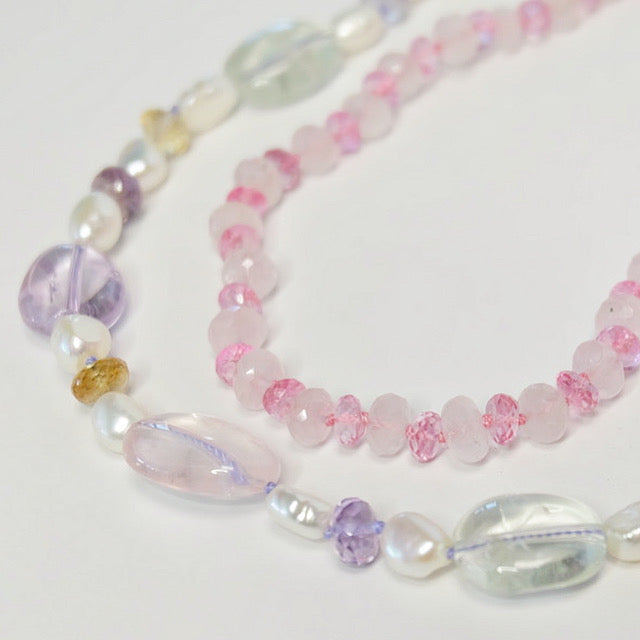 Mixed gemstone bead necklace layered with other beaded jewelry