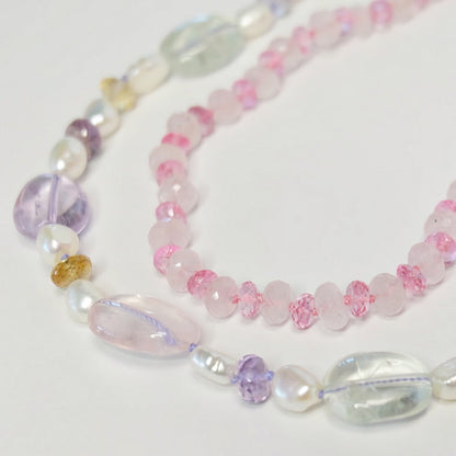 Mixed gemstone bead necklace layered with other beaded jewelry