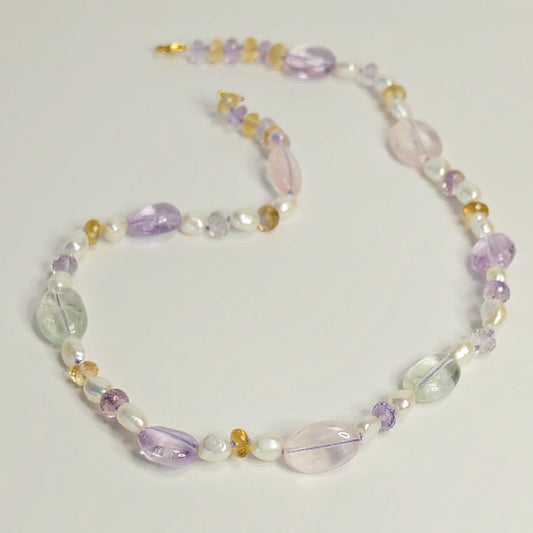 Mixed gemstone beaded candy necklace with ametrine, citrine, rose quartz, green amethyst, and freshwater pearls on lavender silk
