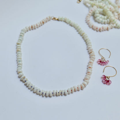 Mother of pearl necklace hand-knotted on rainbow silk, flat lay