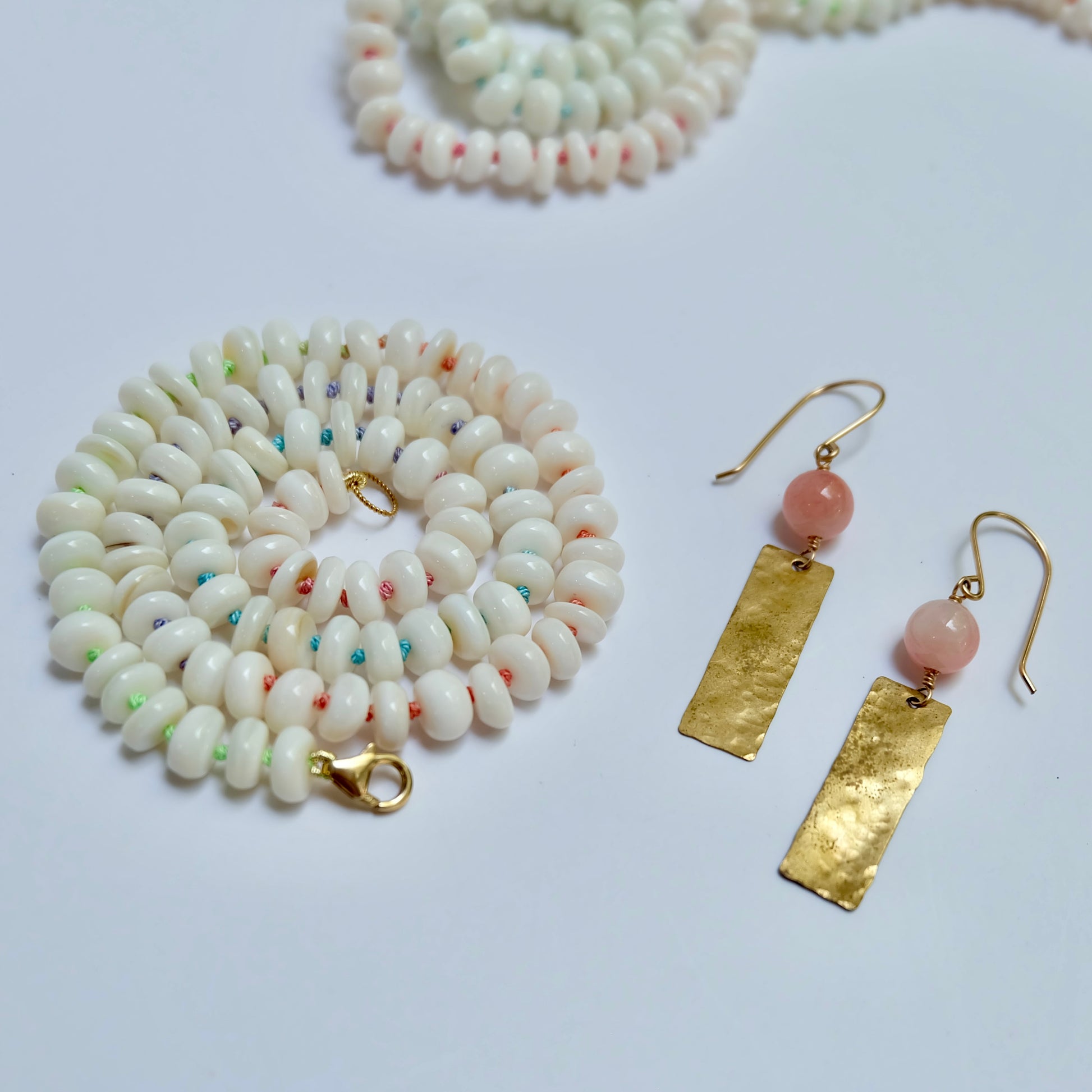 Mother of pearl candy necklace hand-knotted on rainbow silk thread.
