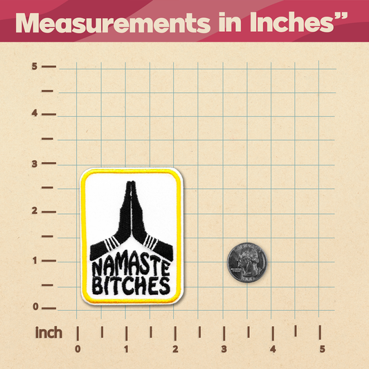 A product measurement graphic showing a rectangular sticker with a yellow border, a black praying hands graphic, and the text 'NAMASTE on a beige grid background labeled in inches, with a coin for scale.